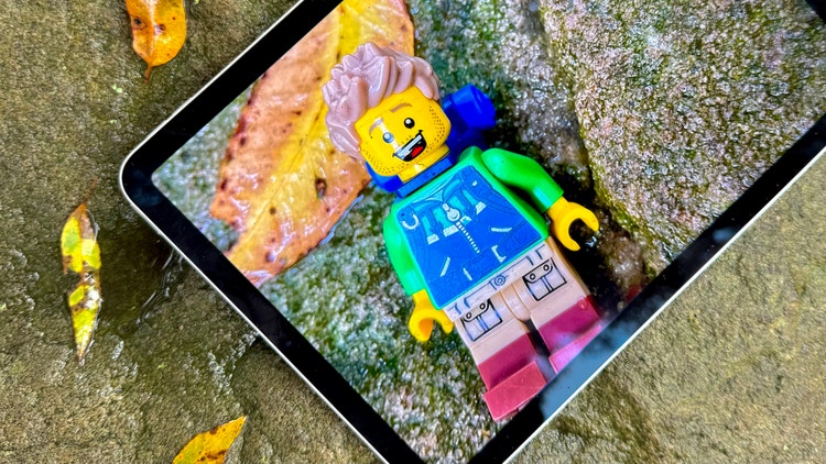 LEGO figure on an iPad in a creek setting, representing creative storytelling inspired by nature.