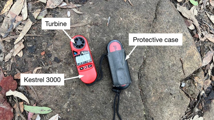 Kestrel 3000 machine lying on a rock labeled with the sensor and a protective case