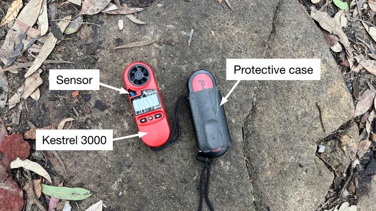 Kestrel 3000 machine lying on a rock labeled with the sensor and a protective case